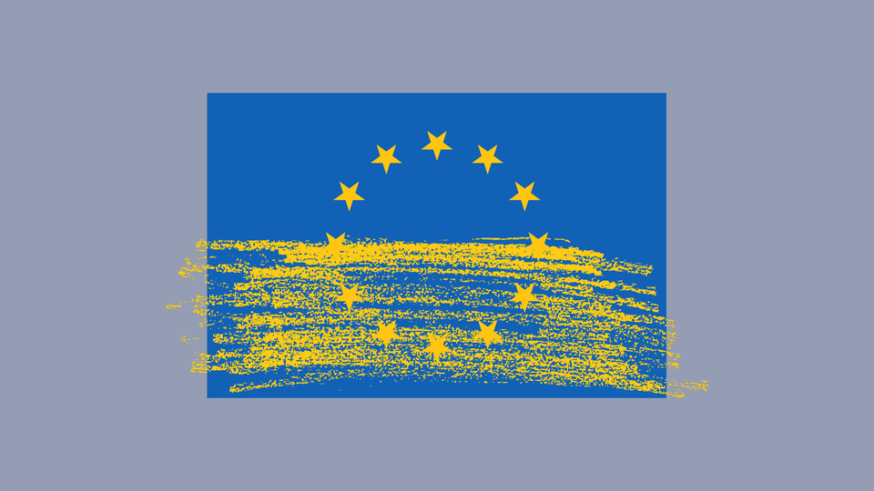 A European Union flag with a yellow brush of paint over it