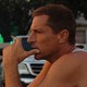Simon Rex stares into the distance with a cigarette in hand in "Red Rocket"