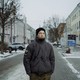 Photo of a man standing in a wintry street