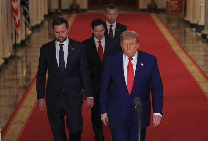 President Donald Trump speaks at a press conference next to J. D. Vance, Marco Rubio, and Pete Hegseth