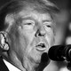 Black-and-white close-up photo of Donald Trump speaking into a microphone