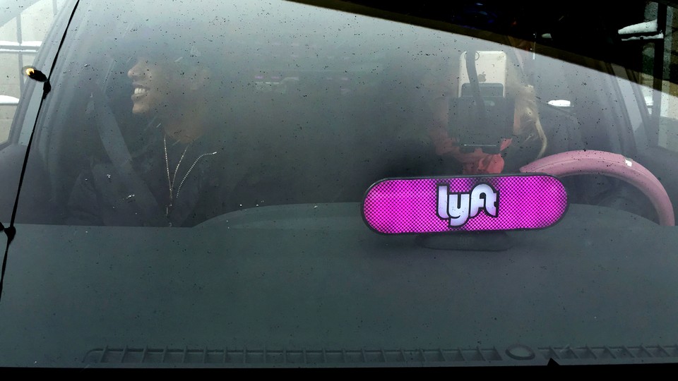 A car windshield with a light-up Lyft sign