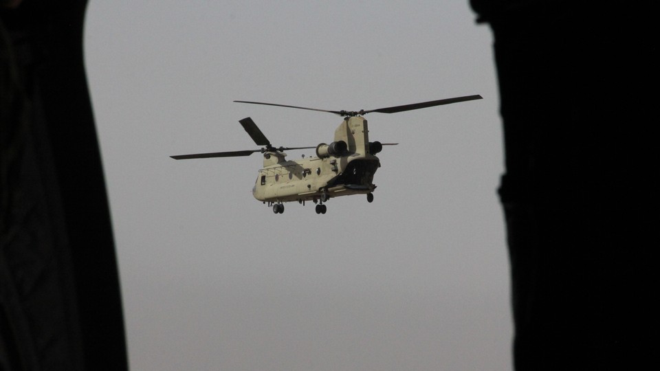 A Chinook military helicopter carrying U.S. Defense Secretary James Mattis flies towards NATO's Resolute Support mission in Kabul on September 7, 2018.