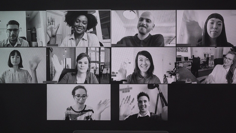 A black-and-white image of a group video call with people waving in each square