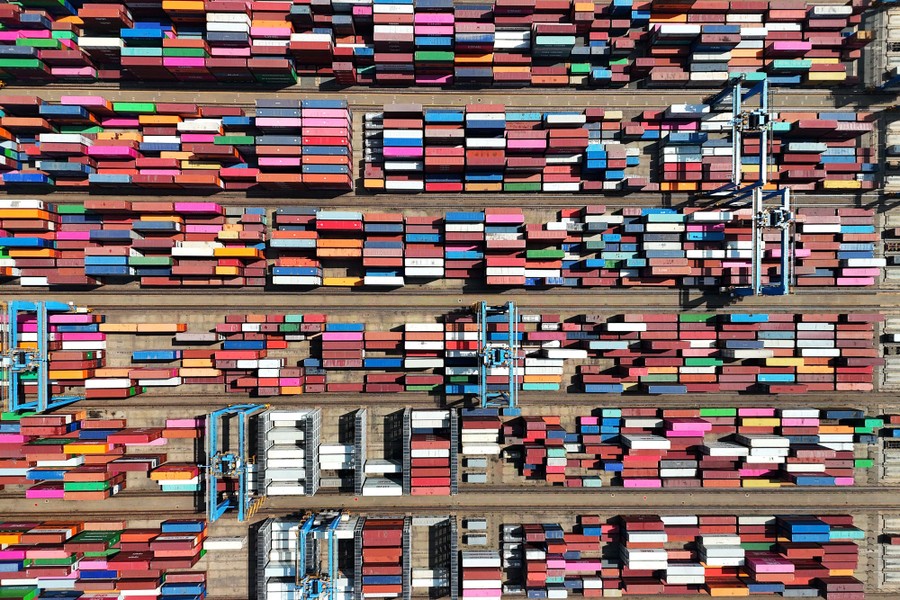 An aerial shot of hundreds of stacked and lined-up shipping containers