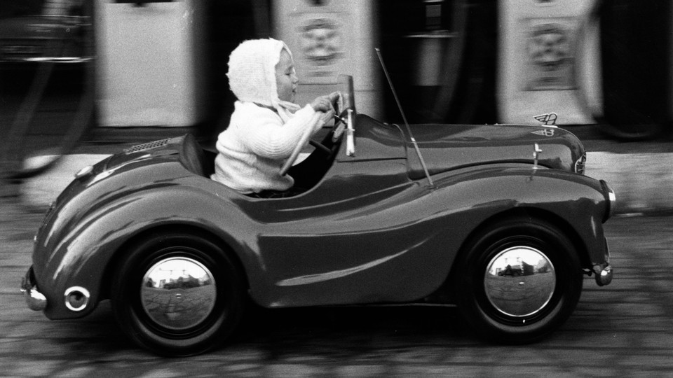 A young girl drives a car