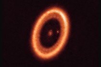 The exoplanet PDS 70c seen as a speck of light within a bright circle, surrounded by a circumplanetary disk