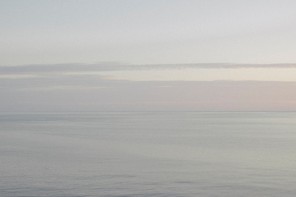 A grainy, hazy photograph of the Black Sea and Abrau Peninsula