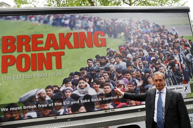 Nigel Farage stands in front of a poster reading 'Breaking Point' that shows immigrants streaming into Europe.