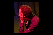 A man under red light watching the election