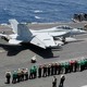 Sailors on the USS Abraham Lincoln take part in an aerial change of command ceremony in the Arabian Sea.