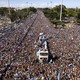 A huge crowd of fans jams up against a bus carrying Argentina's soccer team.