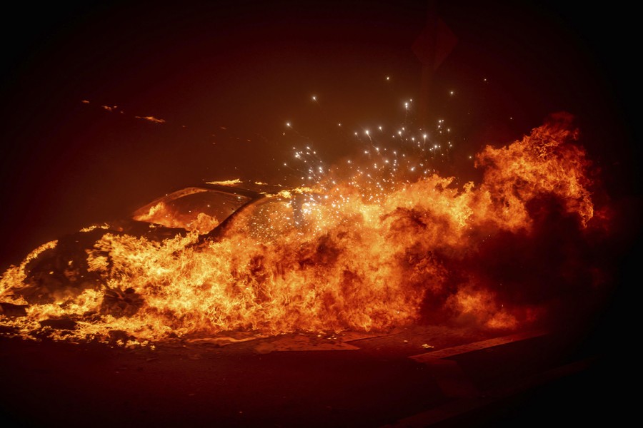 A car is completely engulfed in flames.