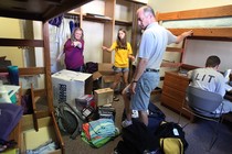 Parents help their daughter, a freshman, move into her dorm at the University of Iowa.