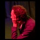 A man under red light watching the election