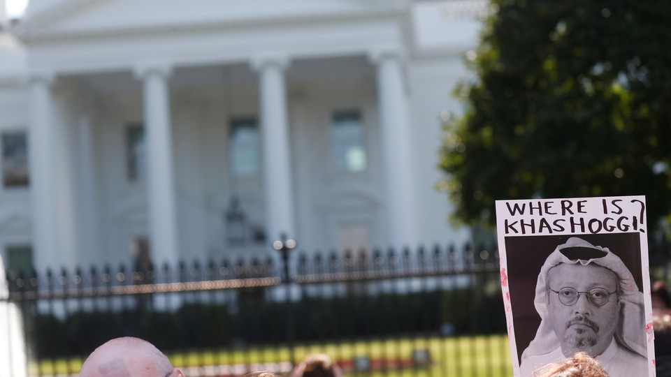 A protestor holds a sign that says "Where is Khashoggi?" outside the White House.