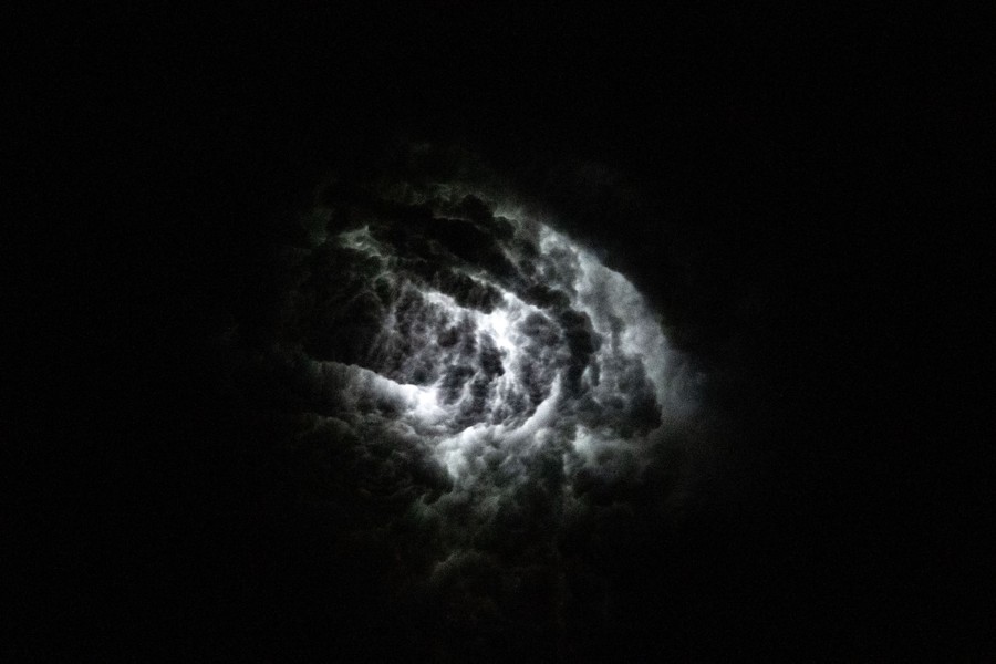 A flash of light is seen withng a cloud.