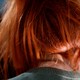the back of a woman's head; she's wearing a read wig