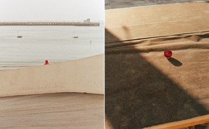 2 photos: small figure in red hoodie sits by shore with 2 sailboats and pier in distance; small red cup centered on large brown table
