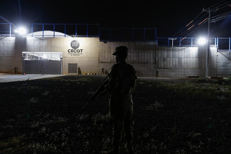 Picture of a soldier standing guard along the perimeter at CECOT.