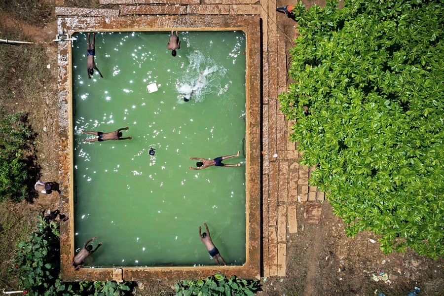 An aerial view of young people swimming in a water tank
