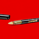 An open pen with Donald Trump's signature on it against a red background.