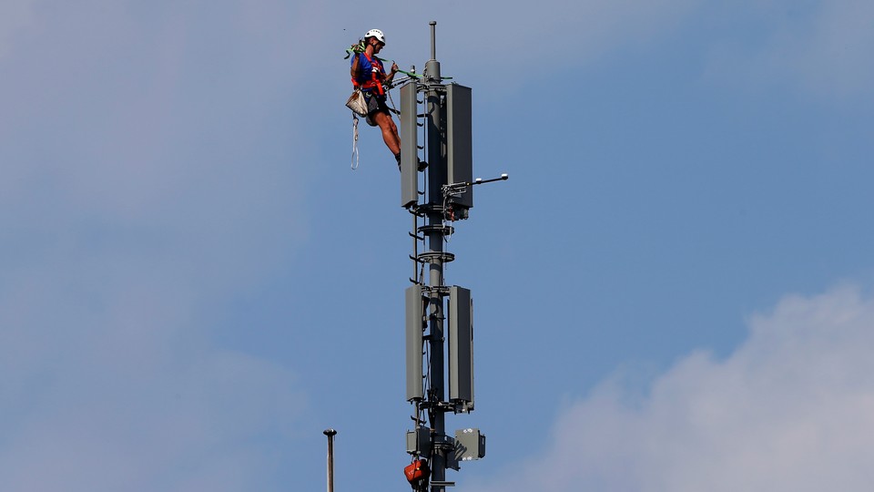 A worker atop a mobile-phone tower