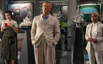 Jessica Henwick, Daniel Craig, and Janelle Monáe stand in a gallery space in "Glass Onion"