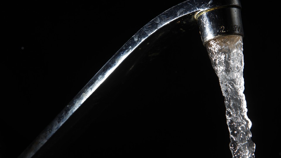 Water pours from a faucet.