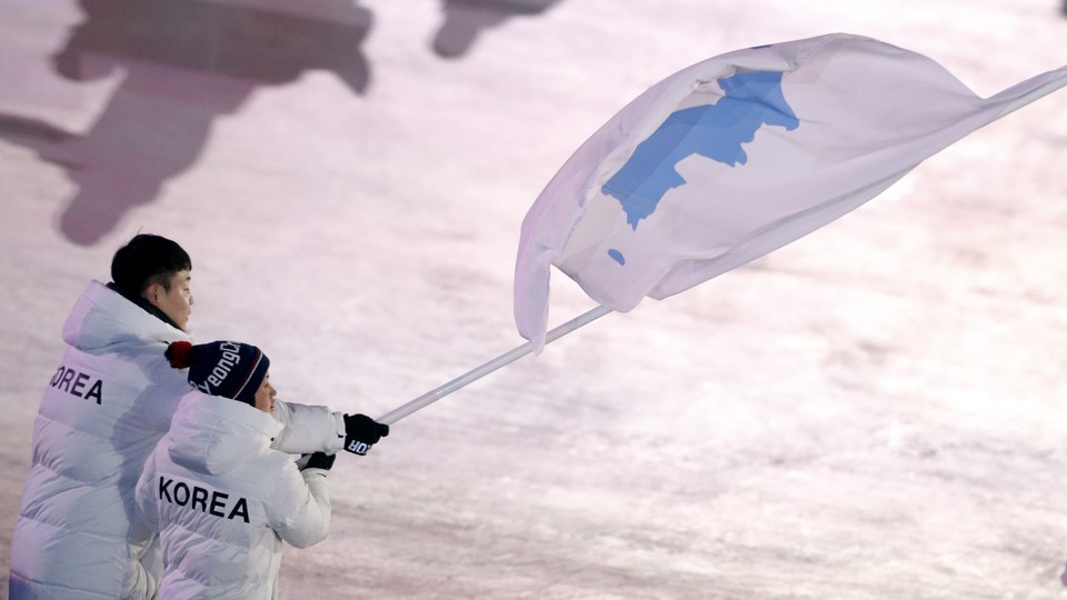 Hwang Chung Gum and Won Yunjong carry the flag during the Pyeongchang Winter Olympics opening ceremony.