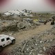 A Reuters truck drives through a bombed refugee camp in Gaza.