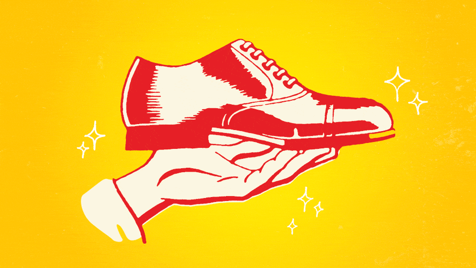 hand holding out a men's shoe