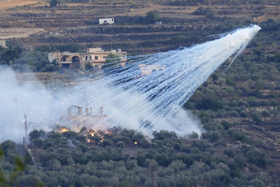 Smoke and projectiles from an aerial blast rain down on a house and its surrounding landscape.