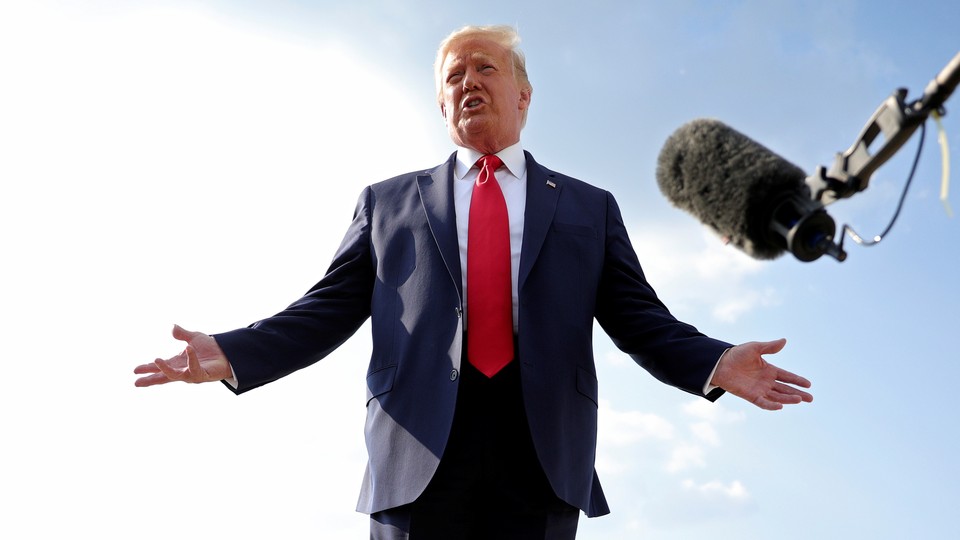 A photo of Donald Trump speaking in front of a boom microphone