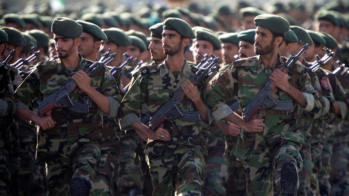Soldiers in fatigues marching in formation