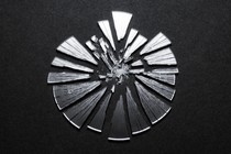 A broken mirror in the shape of the COVID virus