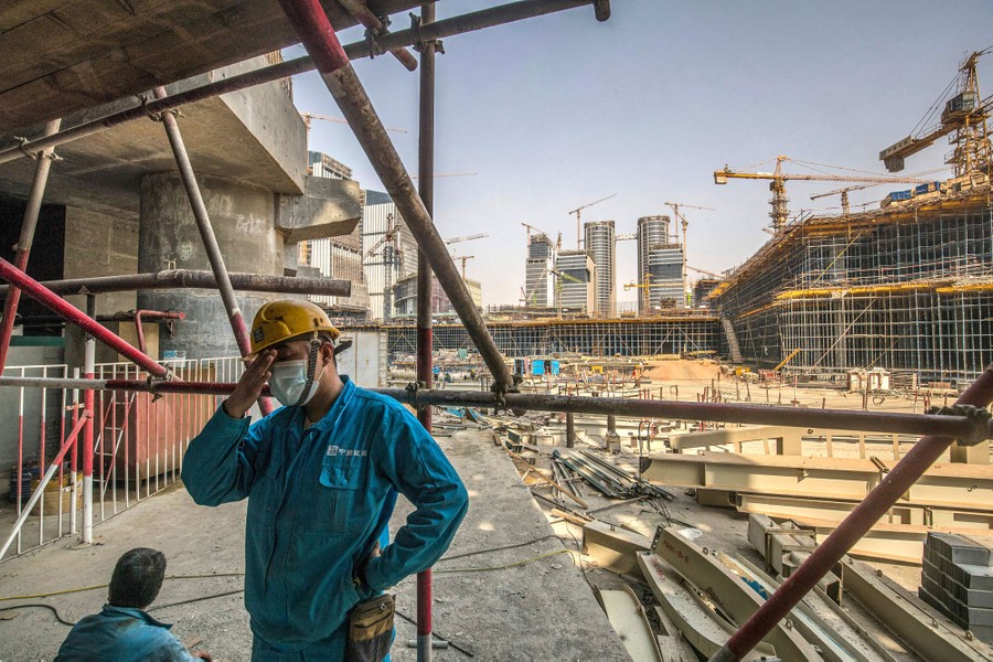 Two workers in a large construction site