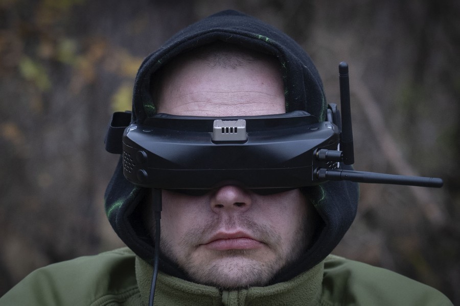 A soldier wears goggles outfitted with antennae.