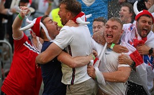 England soccer fans embrace and celebrate.