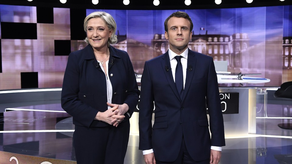 French presidential candidates Marine Le Pen and Emmanuel Macron pose ahead of their televised debate in La Plaine-Saint-Denis on May 3, 2017.