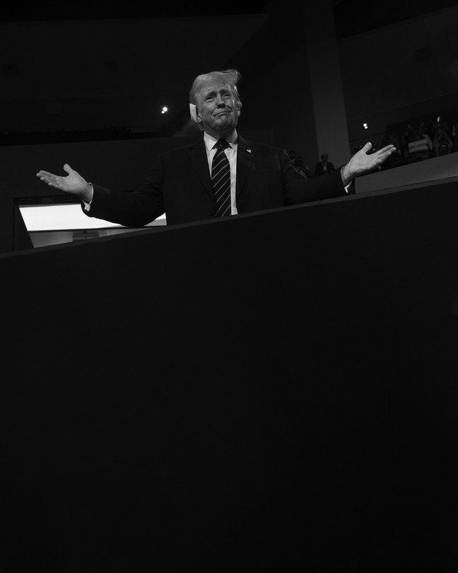 Black-and-white photo of Donald Trump at the RNC with his hands out