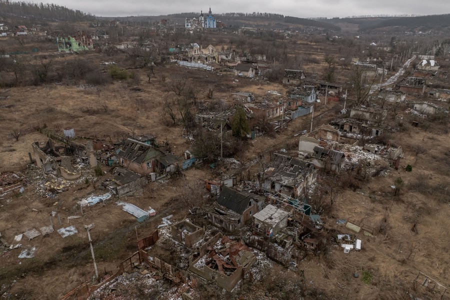 An aerial image of a village, its houses and buildings almost completely destroyed