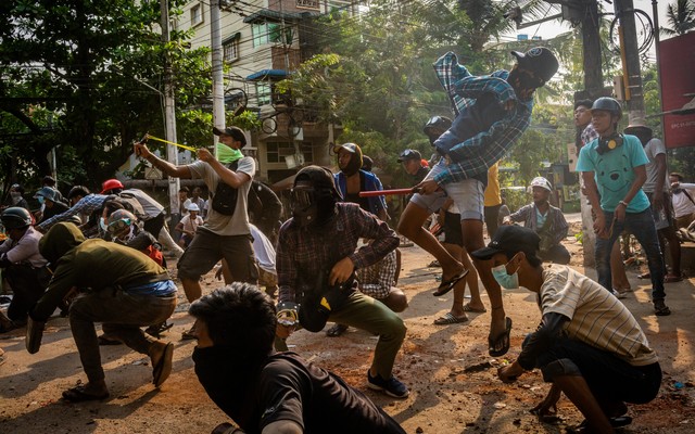 Masked protesters use slingshots and pelt stones.