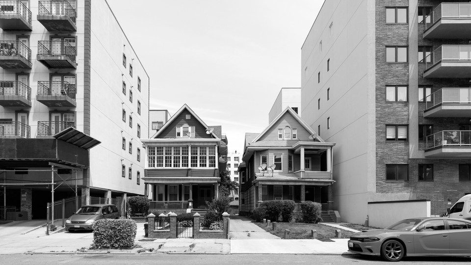 two standalone houses between two apartment complexes