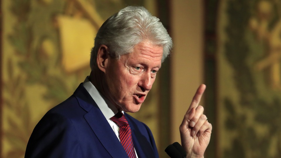 Former President Bill Clinton speaks into a microphone.