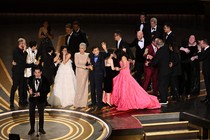 Jonathan Wang accepting the Best Picture Oscar for "Everything Everywhere All at Once," with the rest of the cast and crew behind him