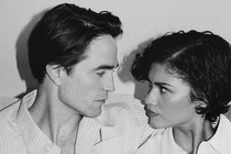 A black-and-white photo of Robert Pattison and Zendaya embracing and looking at each other.