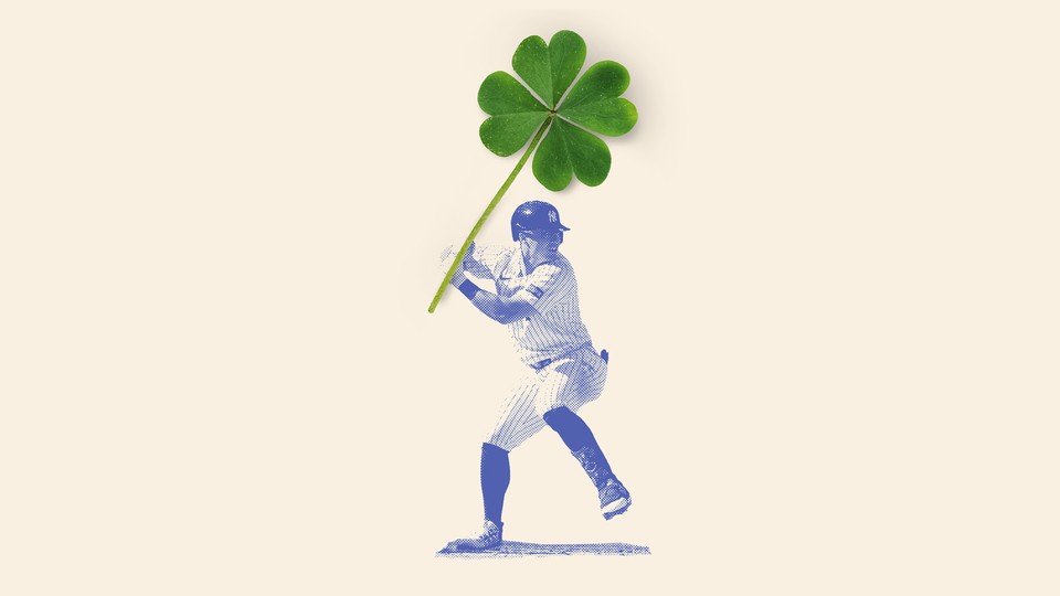 A New York Yankee swinging a giant four-leaf clover