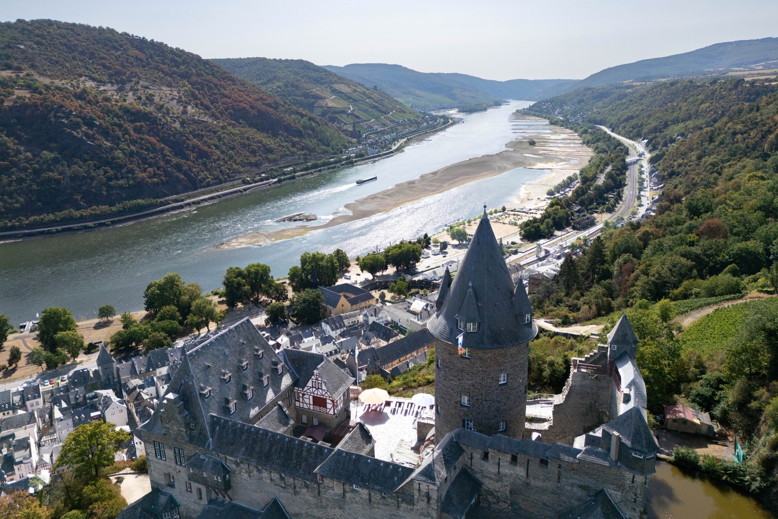 A river at low water levels, seen beneath a castle in Germany.