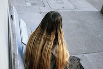 A young girl with her back to the camera